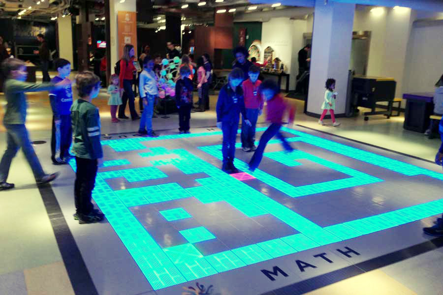 Children playing Sokoban on the floor